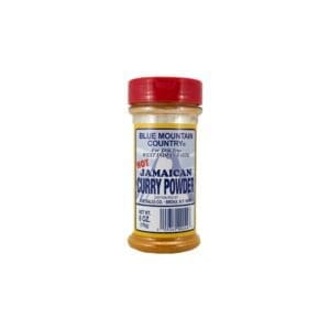 A jar of curry powder on top of a white table.